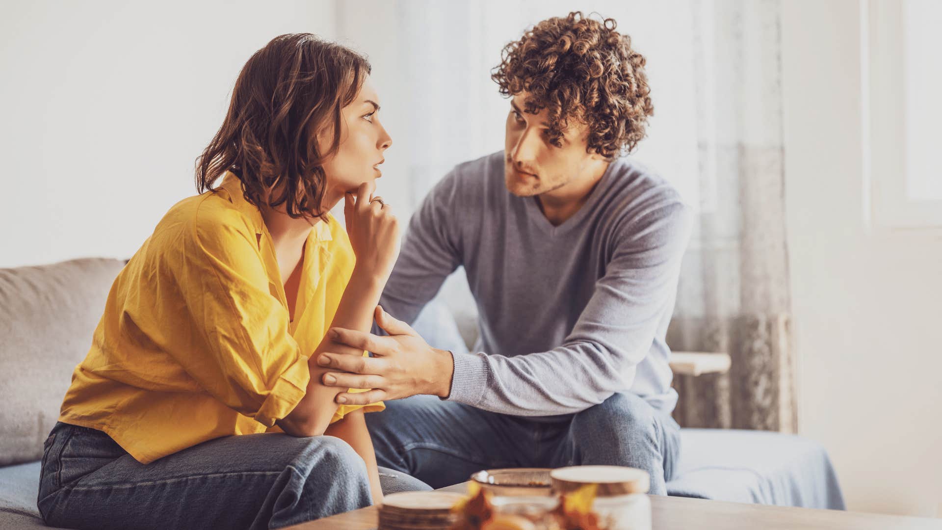 couple having a serious talk on a couch