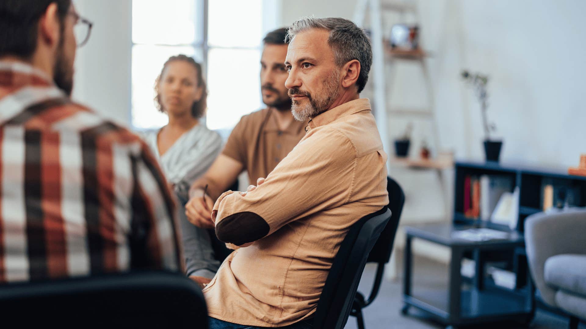 man quietly observing in a group