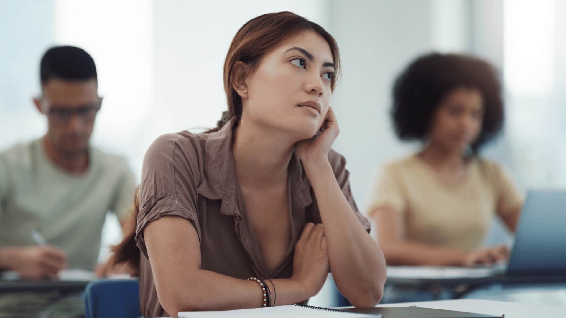 woman who seems to be distracted in class