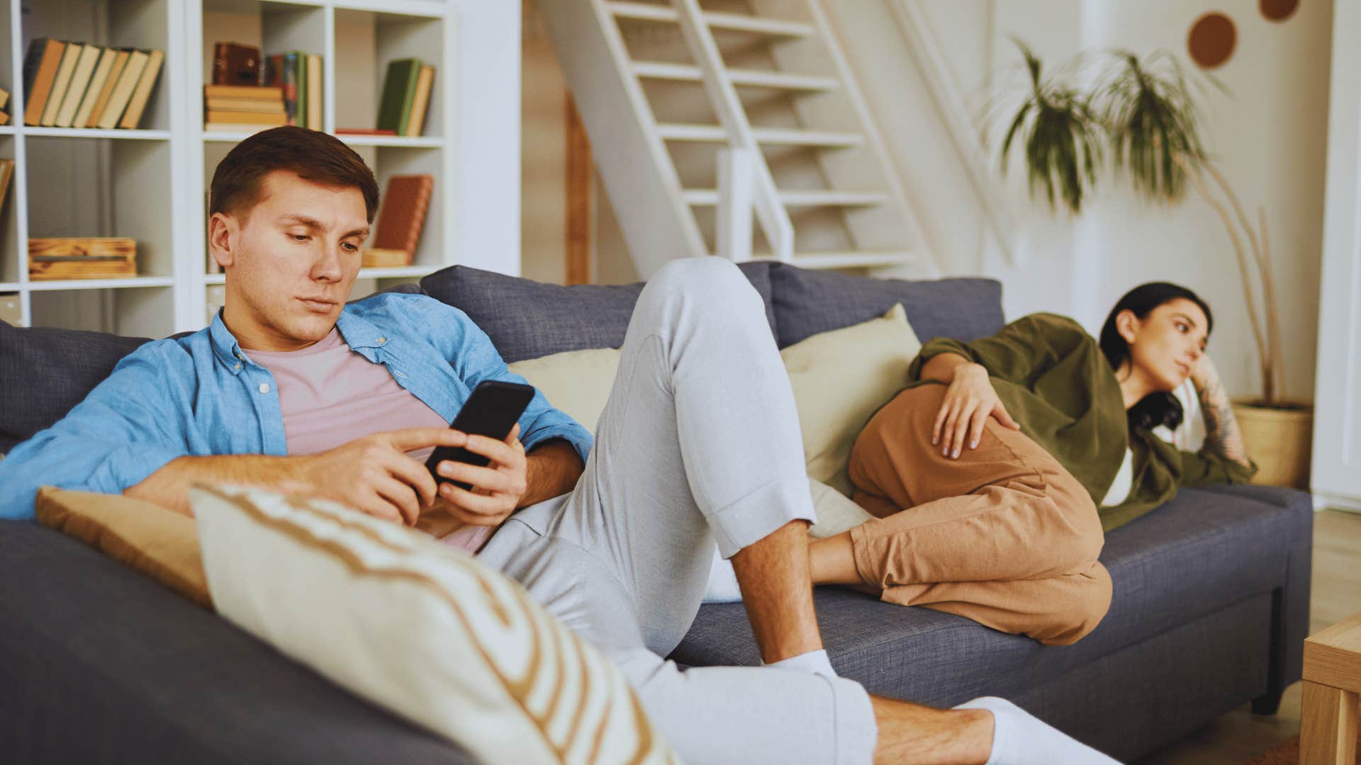 couple on couch avoiding deep conversation