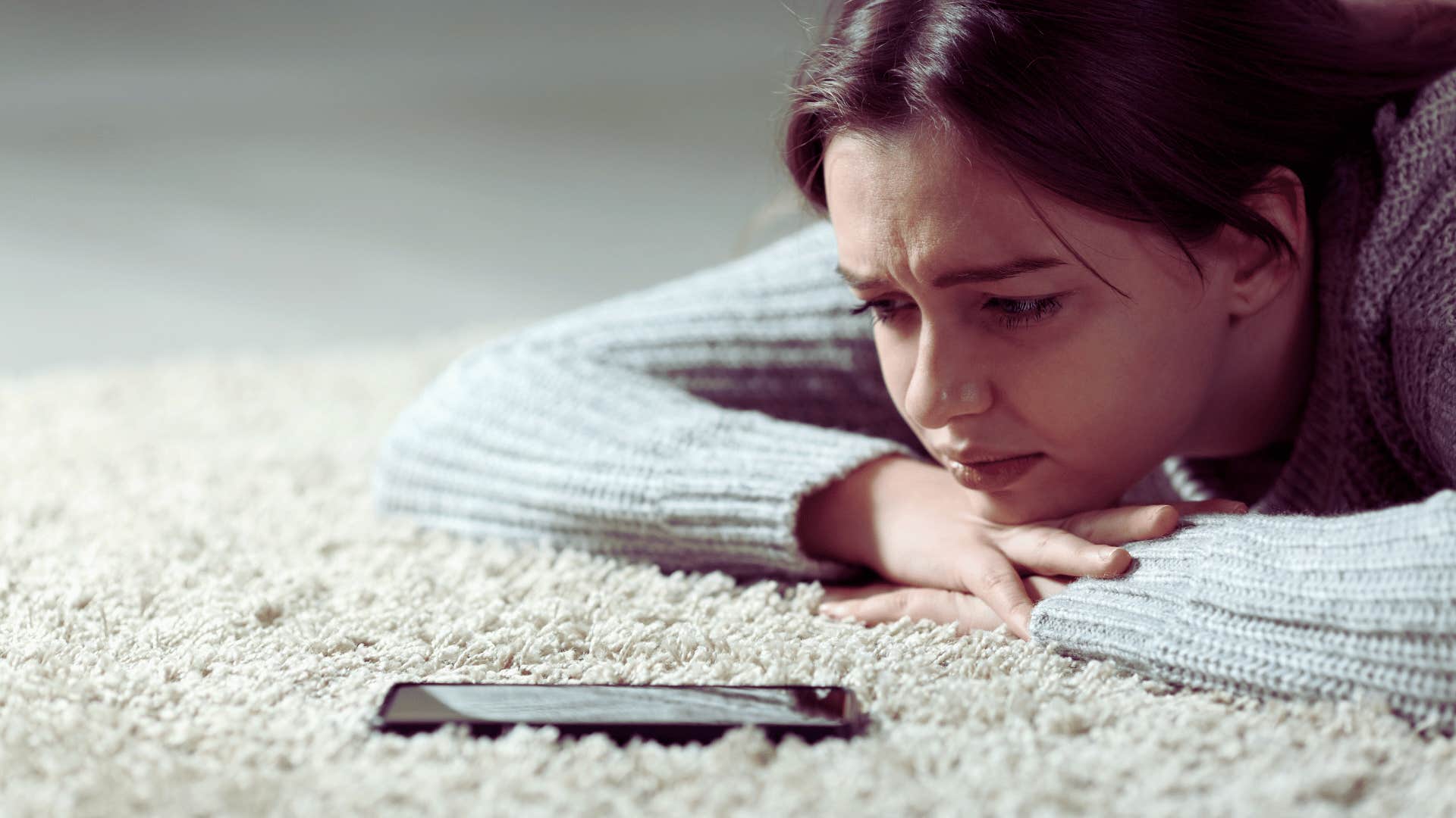 woman waiting for someone to reach out by text