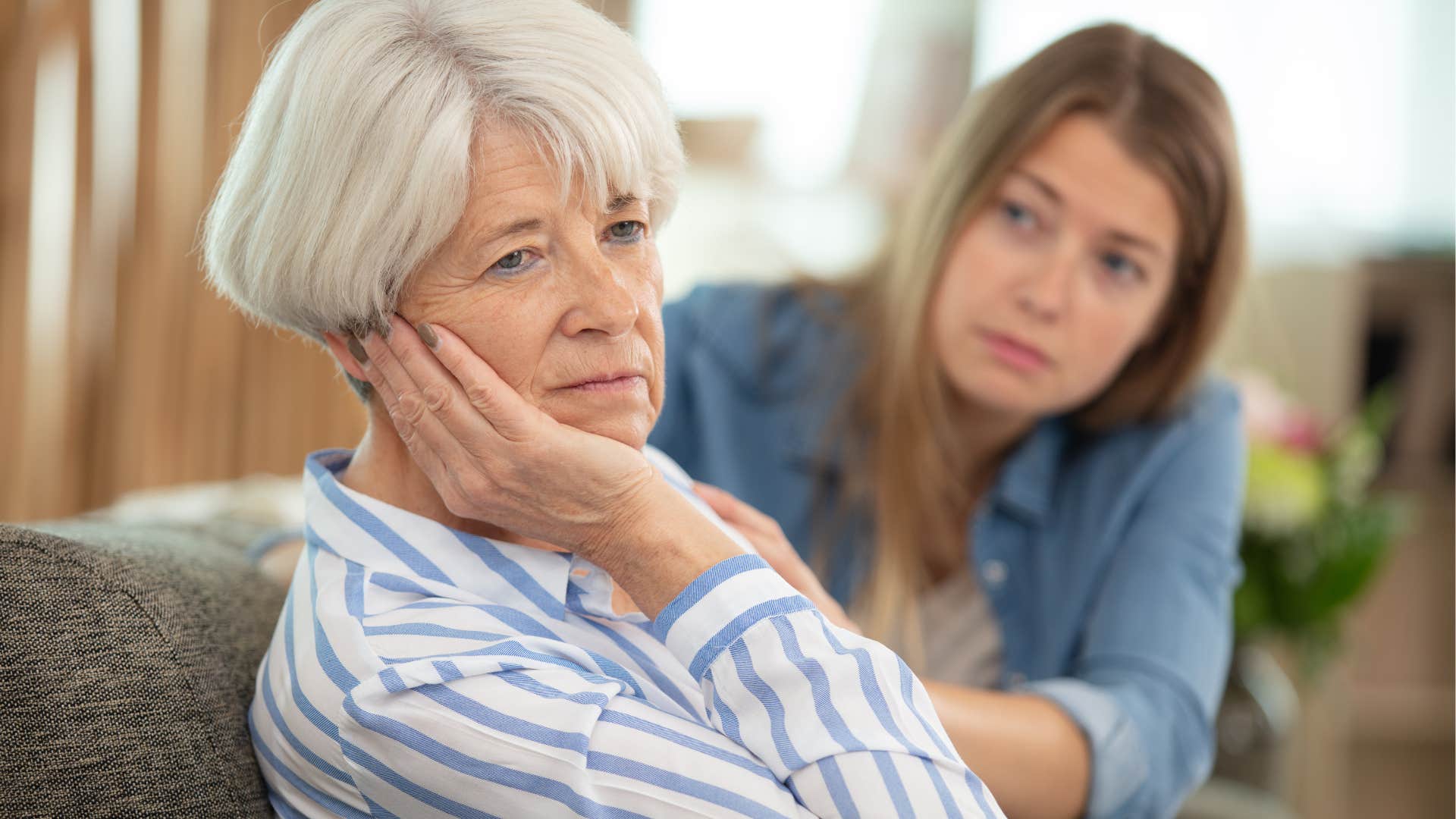 Older woman turned away from her upset daughter.