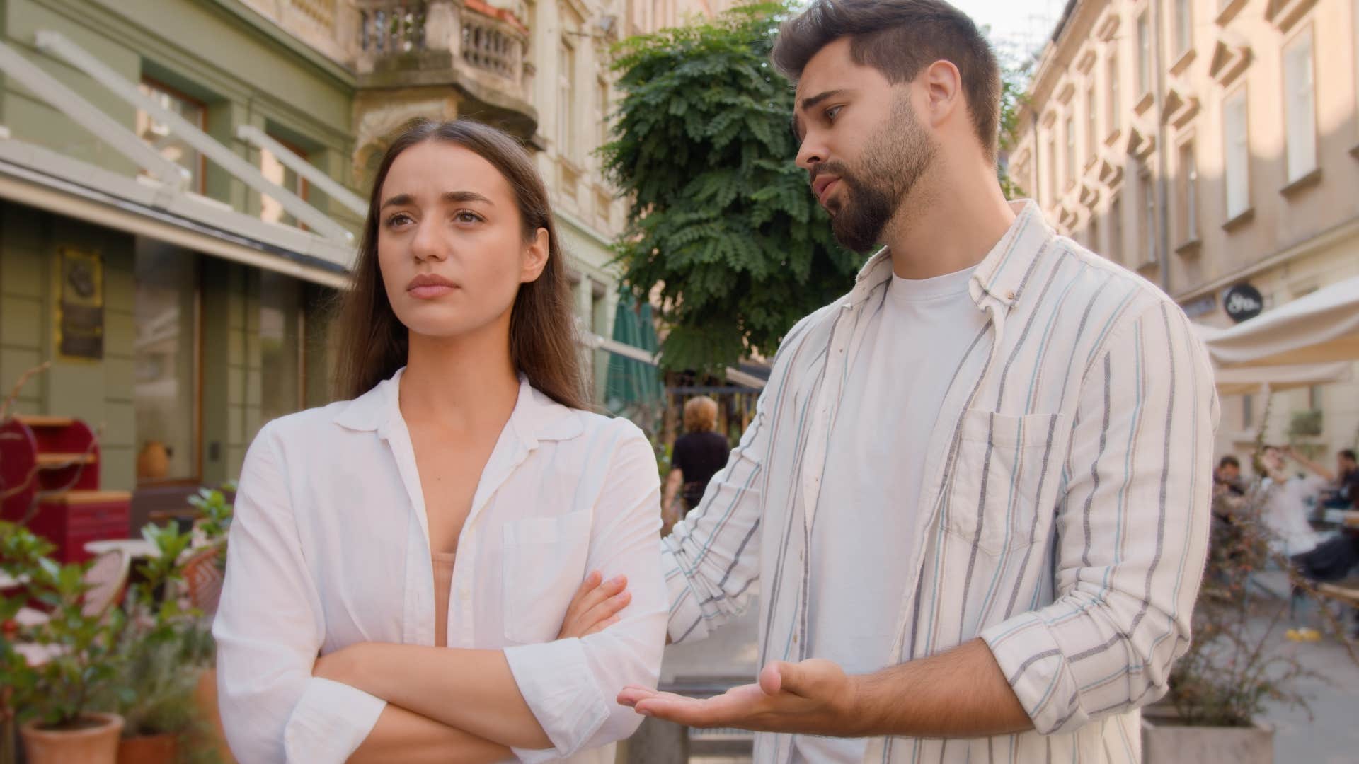 Woman looking upset next to her partner.