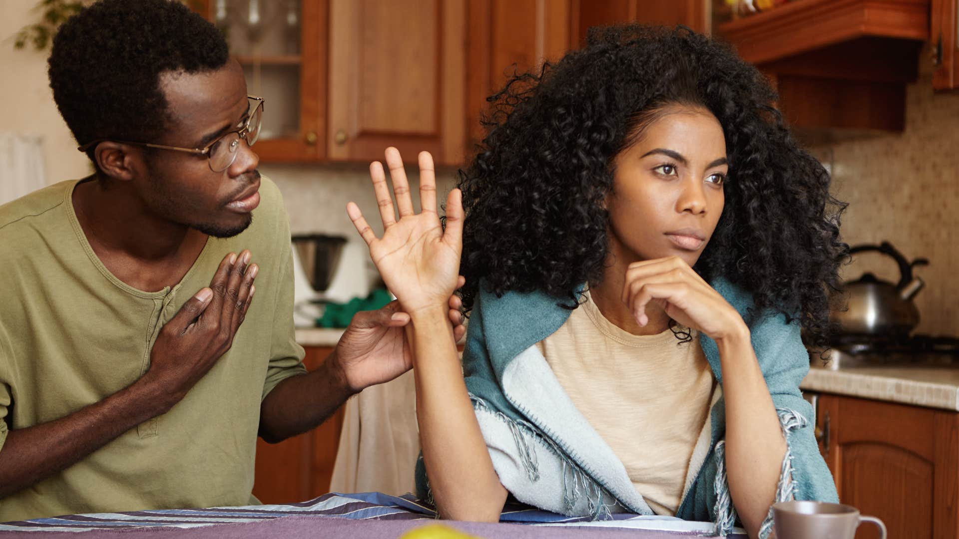 Woman holding her hand in her partner's face.