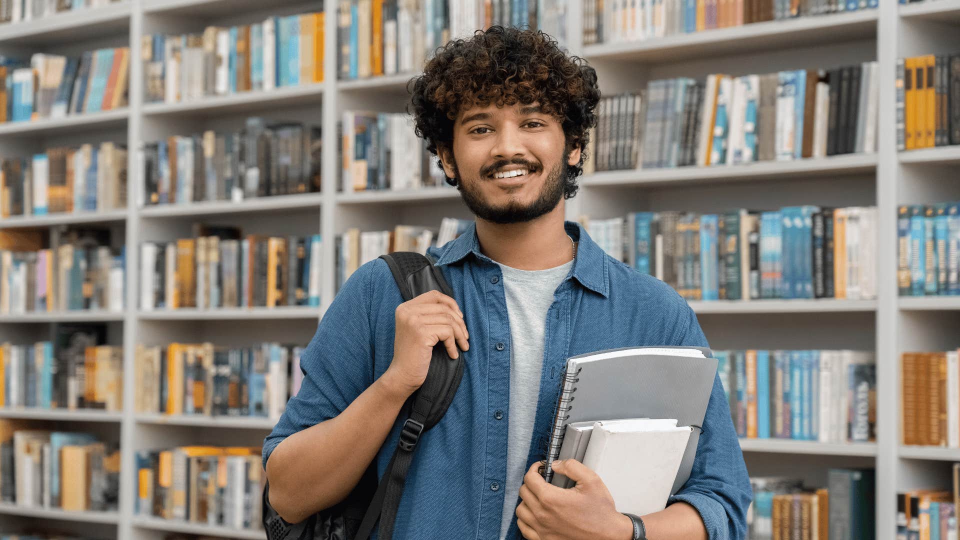 man standing in a library