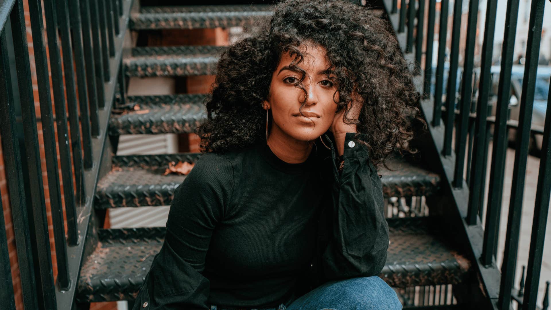 authentic real woman sitting on staircase