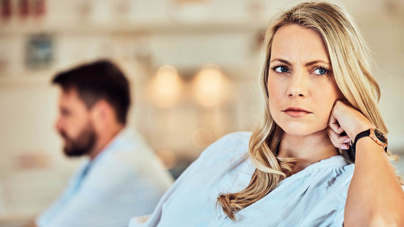 unhappy woman with unhelpful man in background