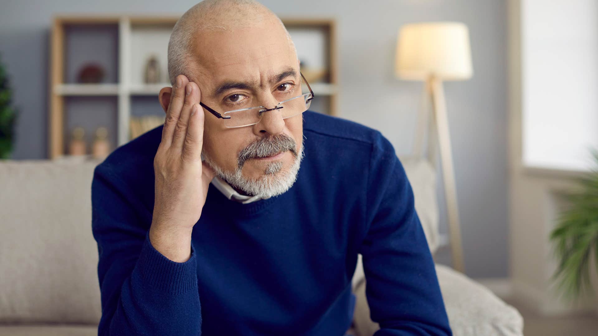 Older man looking apprehensively at the camera.