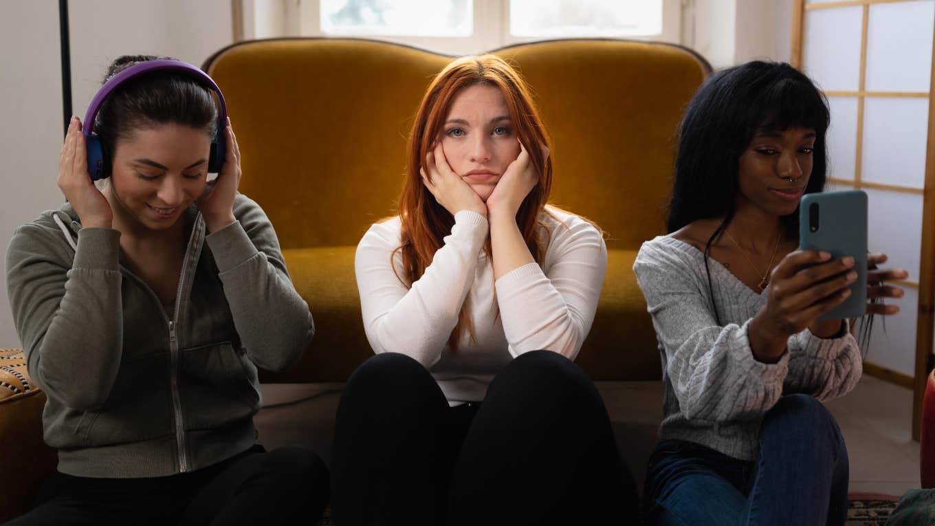 woman annoyed with group of friends next to her