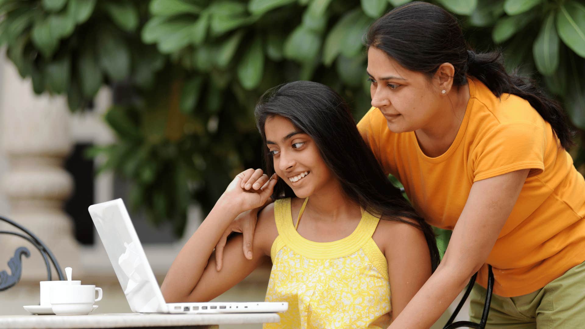 mom looking at daughter's laptop