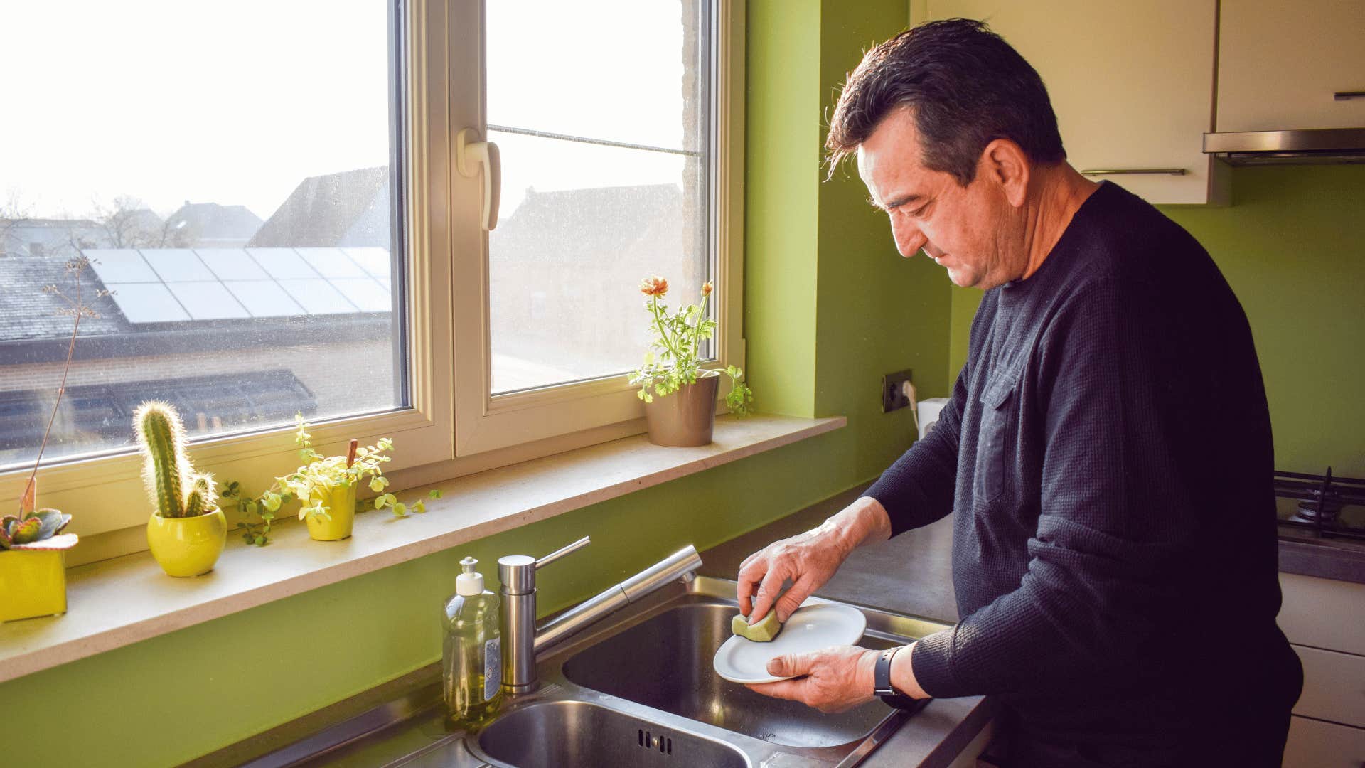 man cleaning dishes