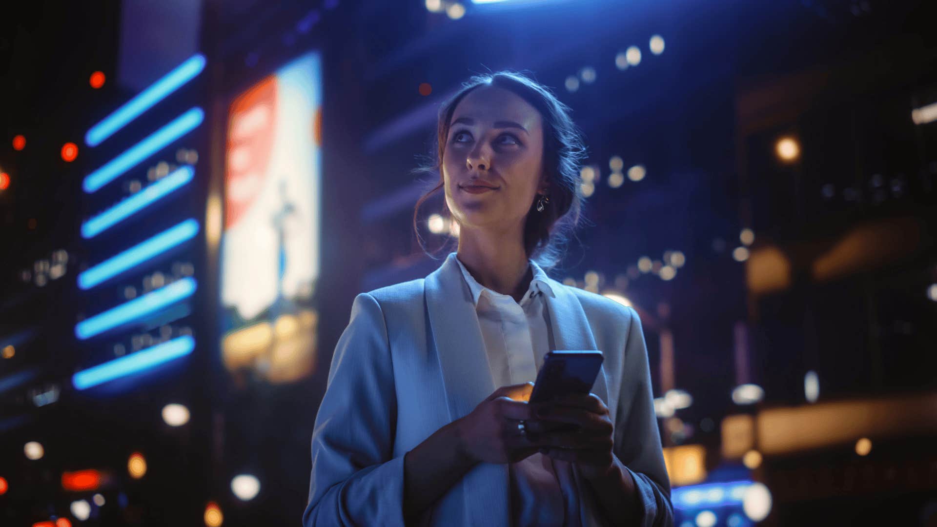 confident woman walking with her phone in the city