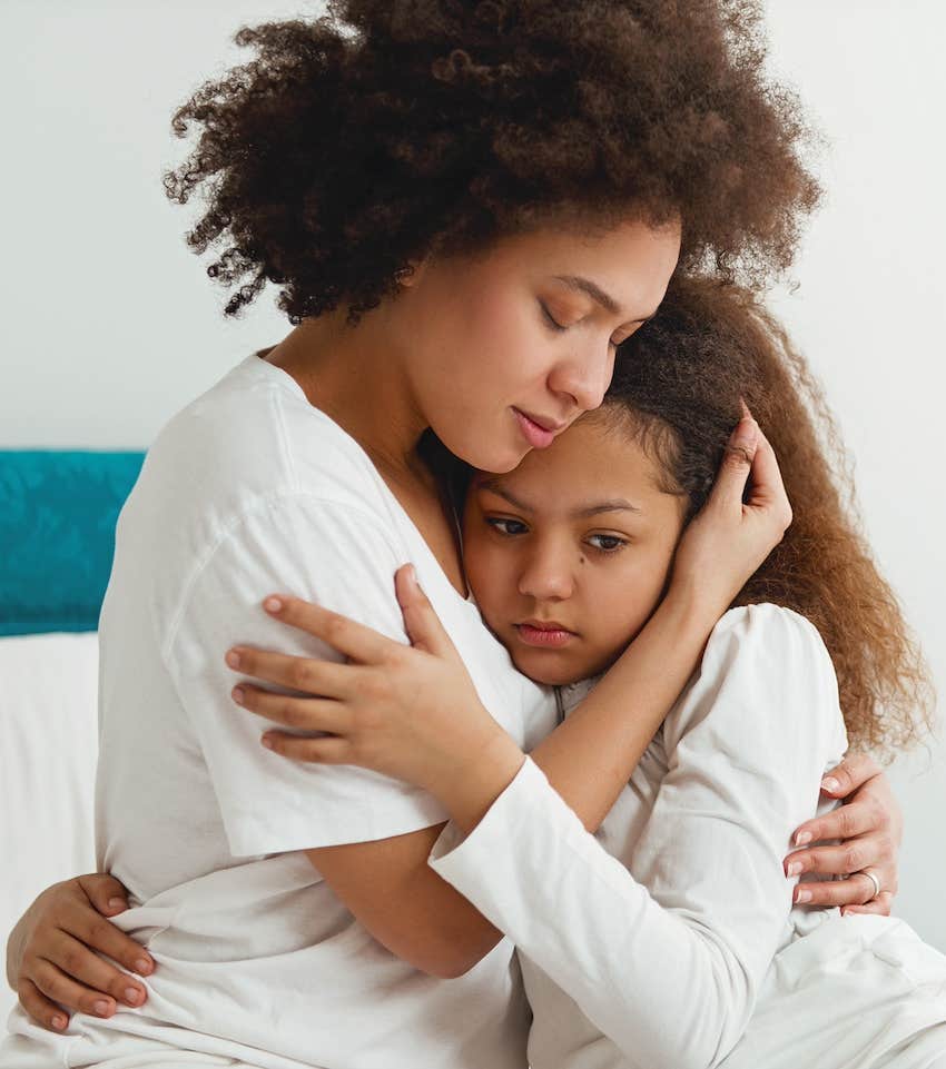 Mother hugs child