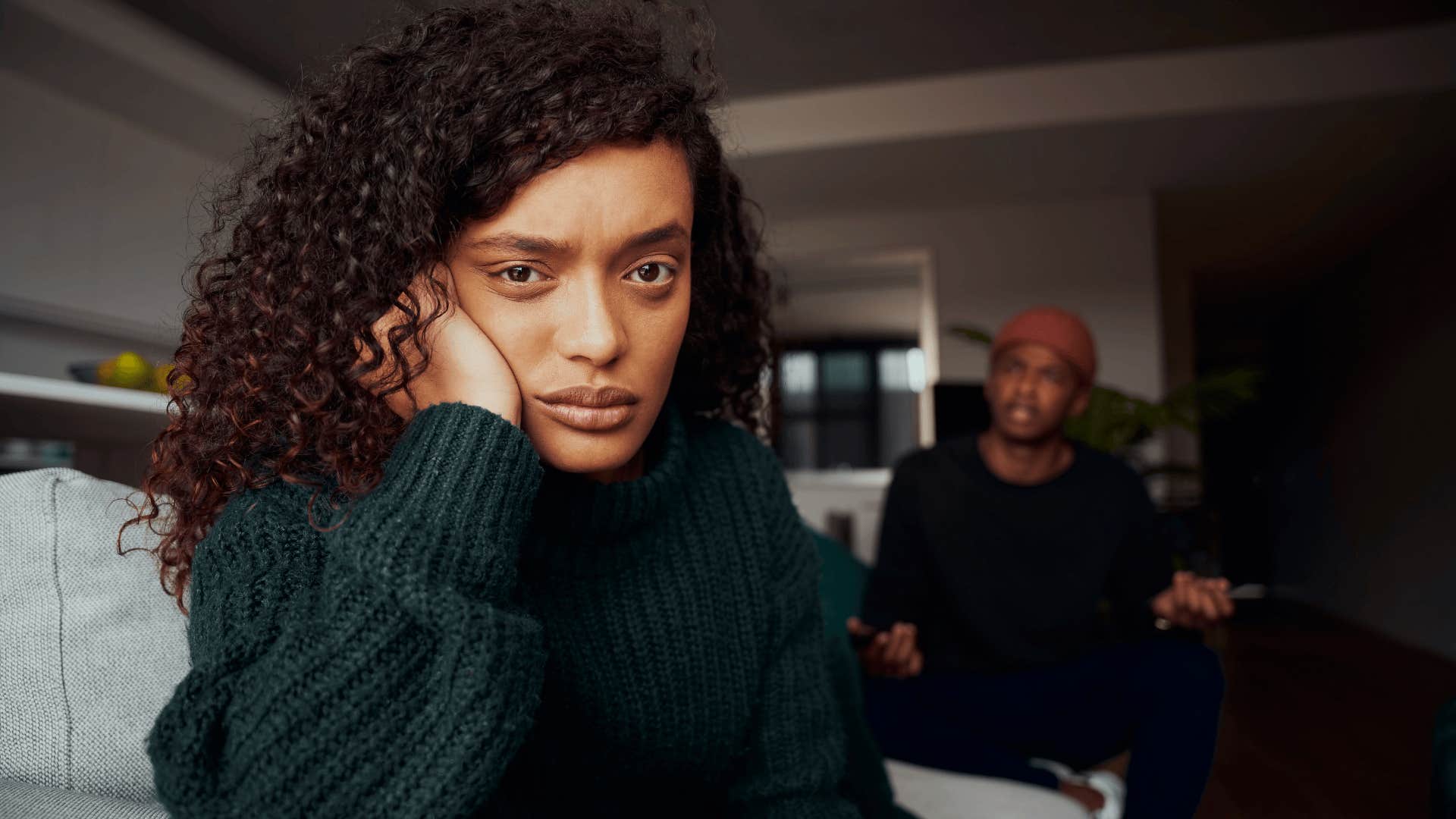  female angry with her boyfriend while fighting on the sofa in modern apartment