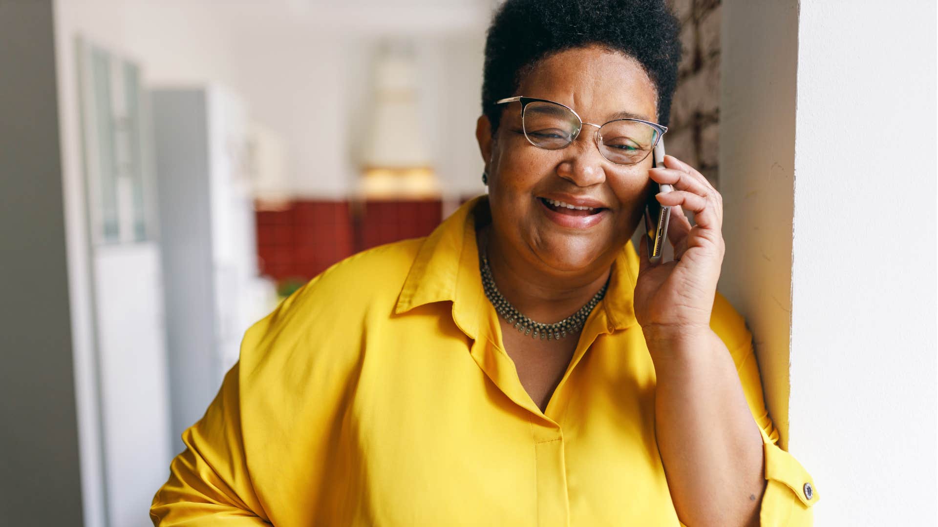 Woman smiling and talking on the phone.