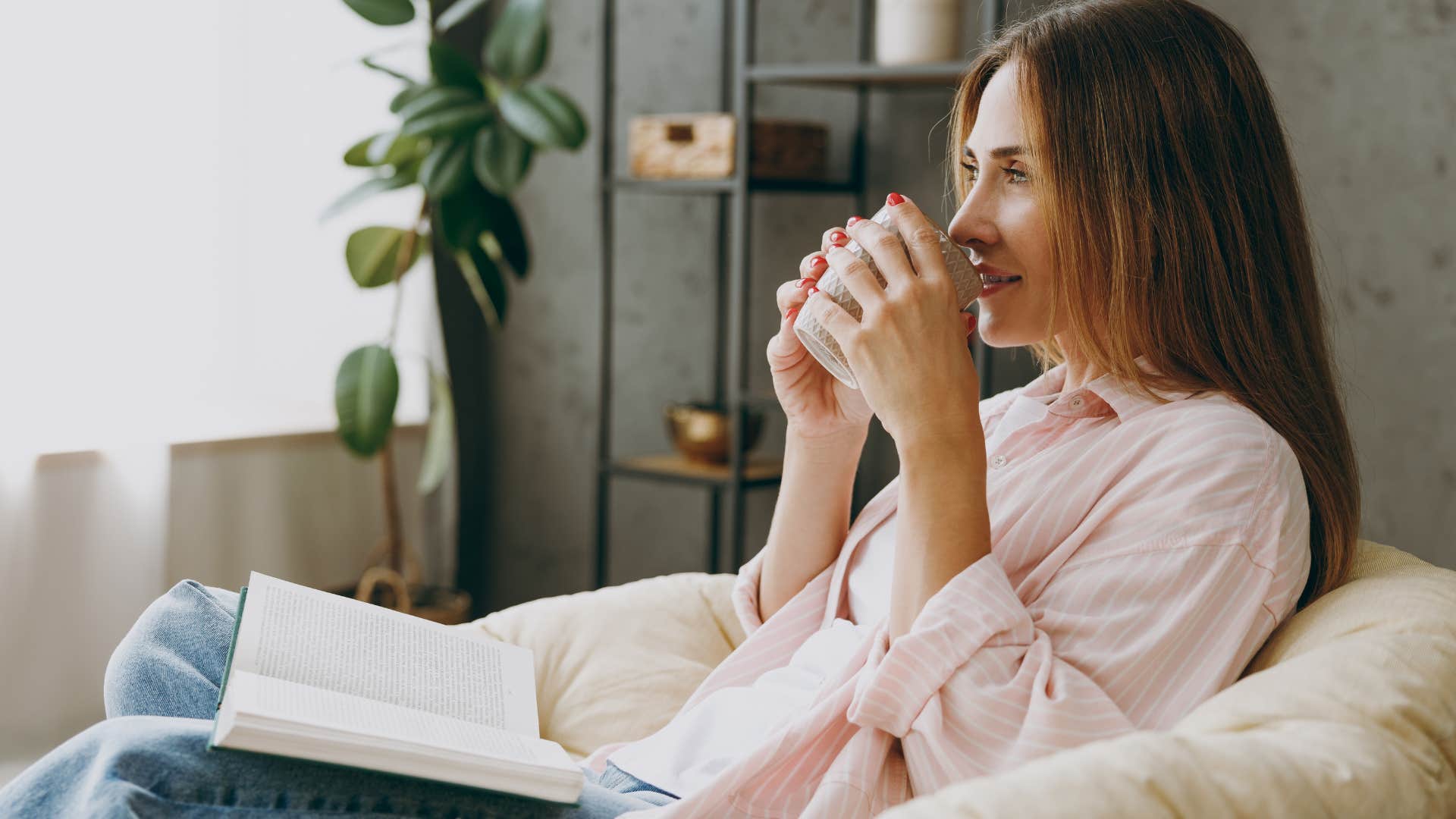 Woman smiling and drinking coffee from her mug. 