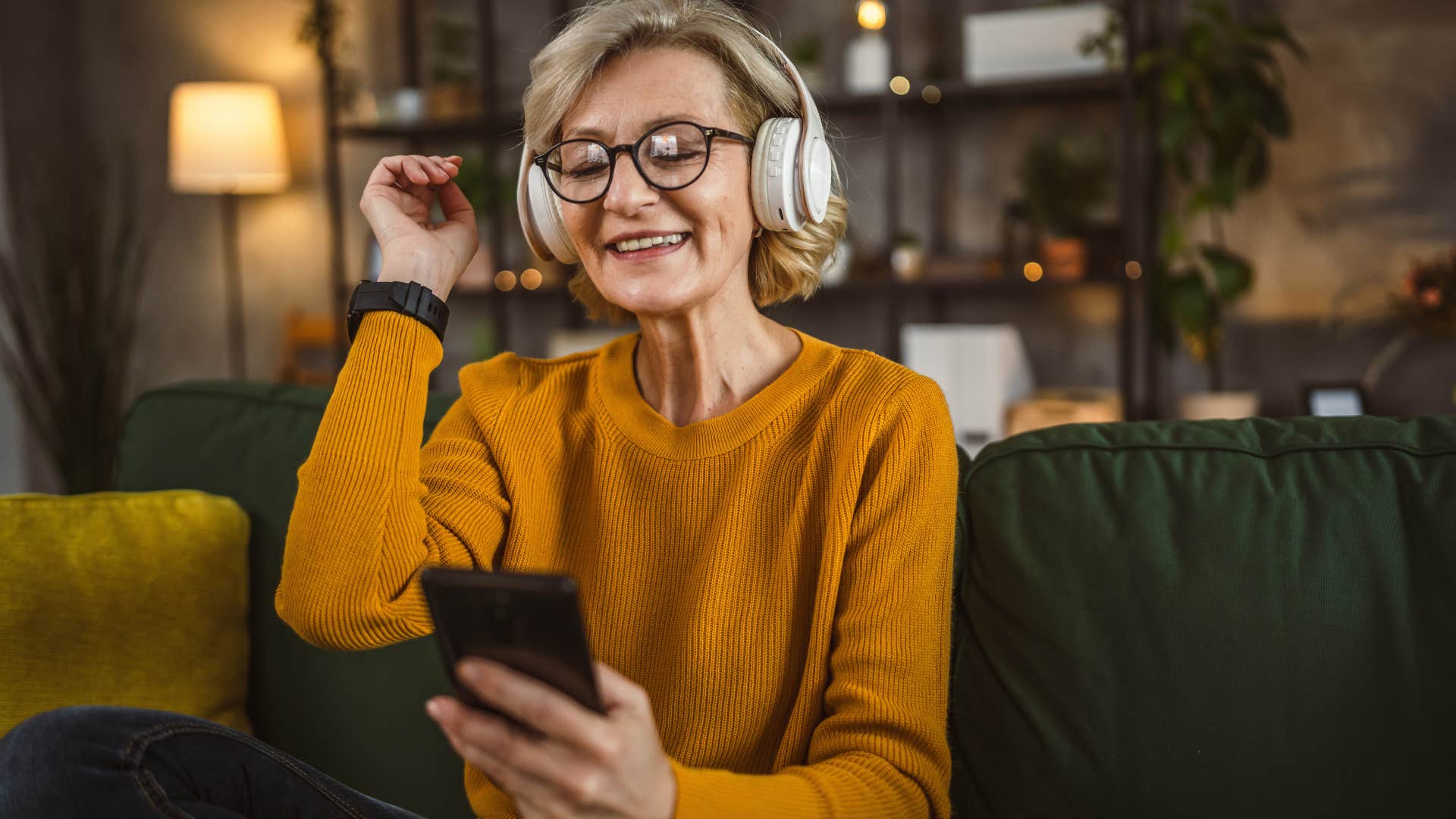 Woman wearing headphones smiling.