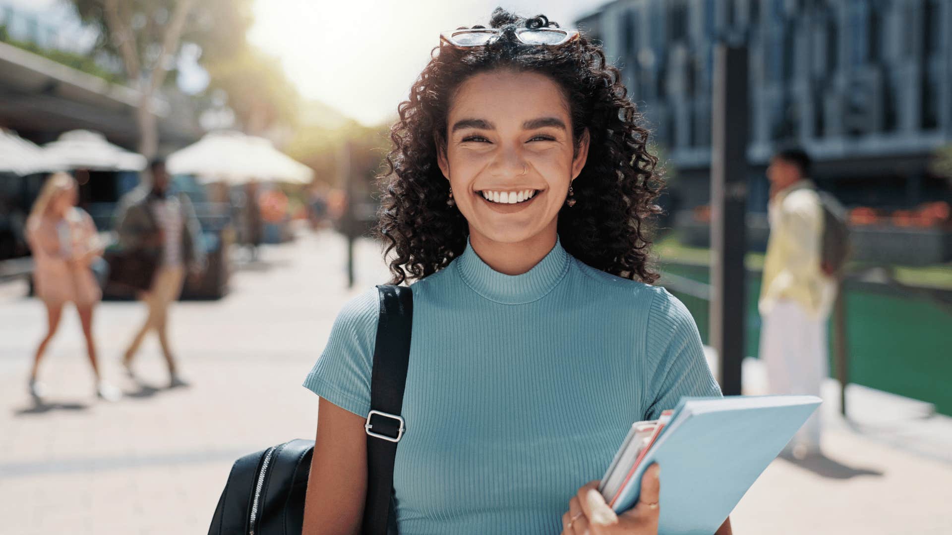 woman smiling with a backpack