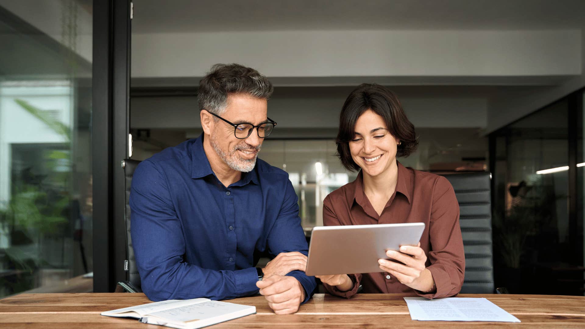 businesspeople looking at tablet