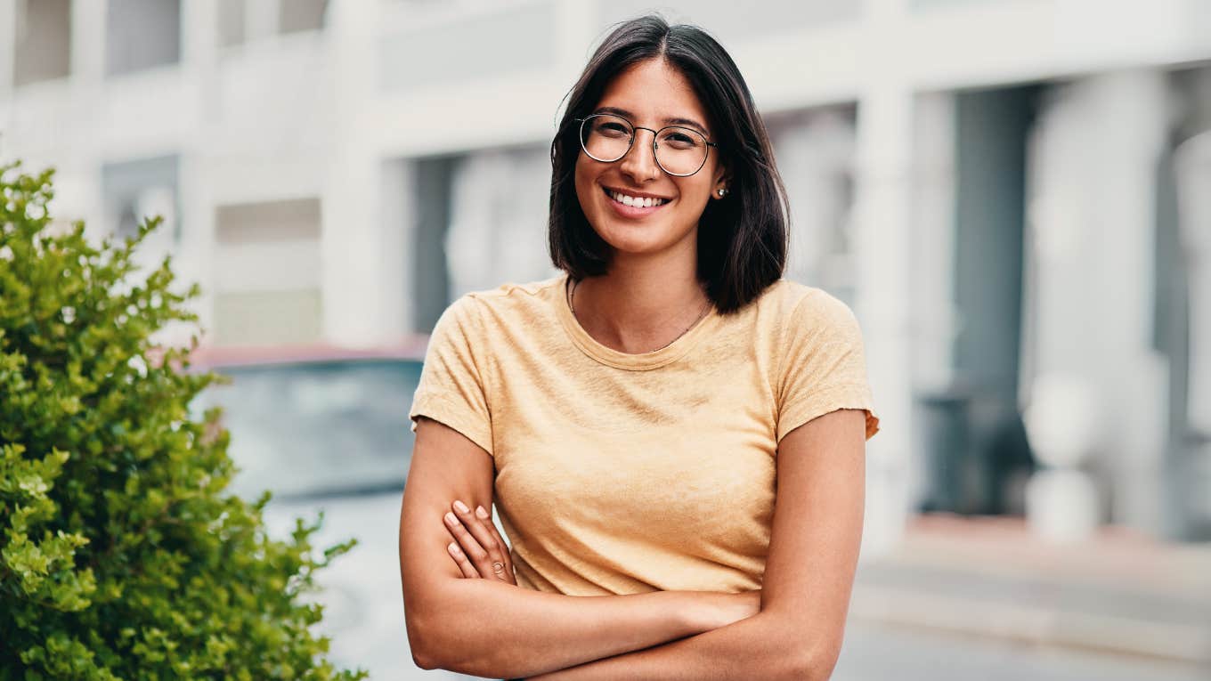 Smart woman standing confidently outside. 