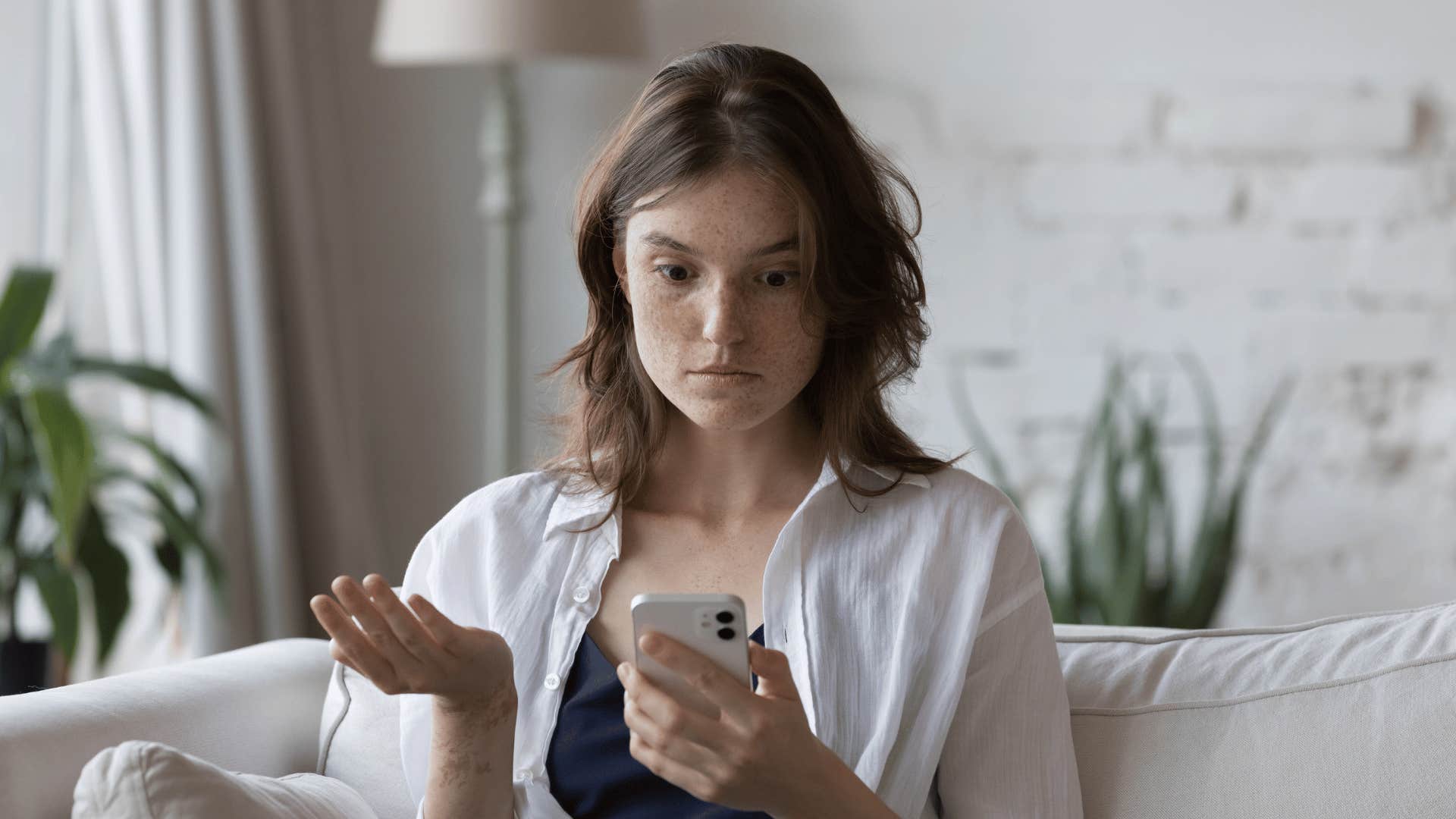 upset woman looking at phone