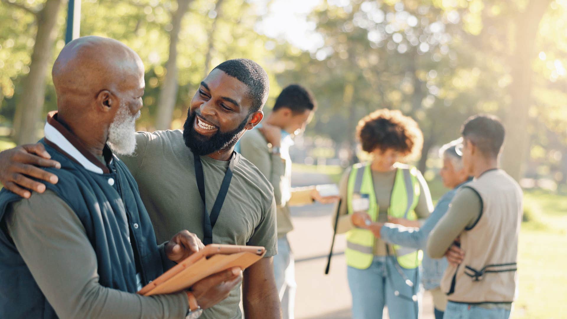 man smiling and talking to another man