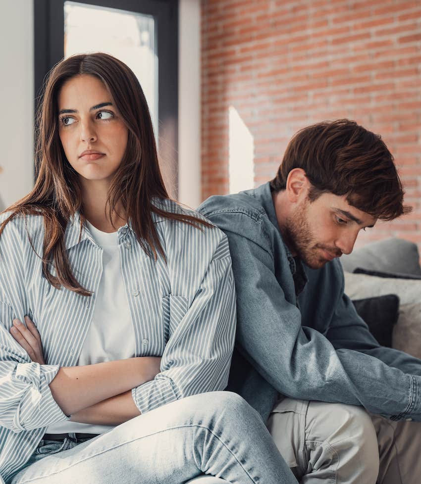 Sad man looks down while woman rolls her eyes