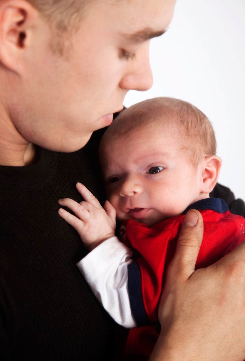 young man with newborn baby