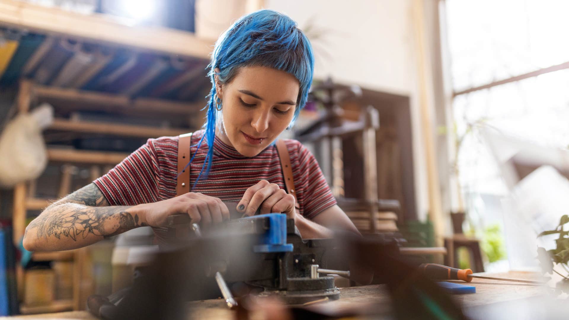 Young woman doing woodwork in a workshop