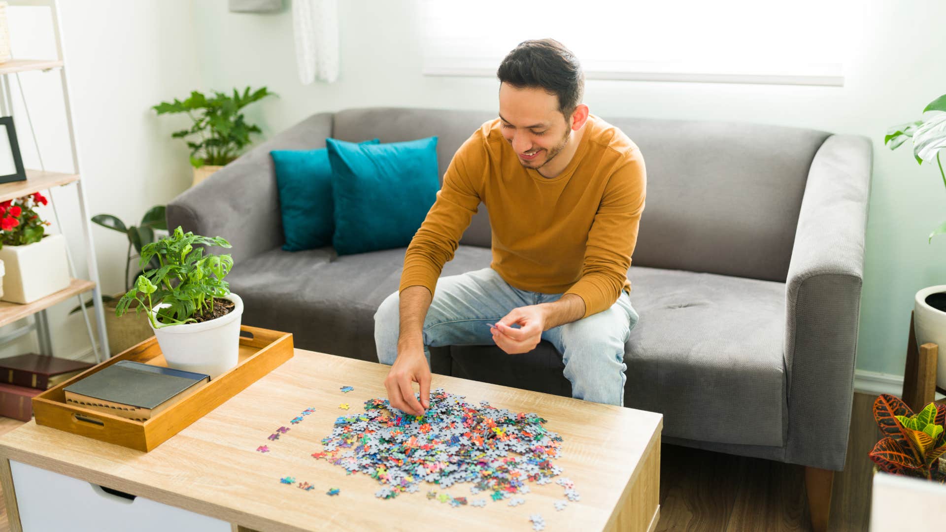 Happy man doing a mental health activity while resting in his living room