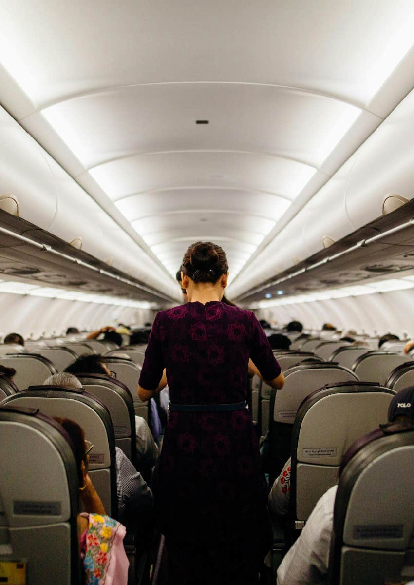 people standing in aisle of airplane