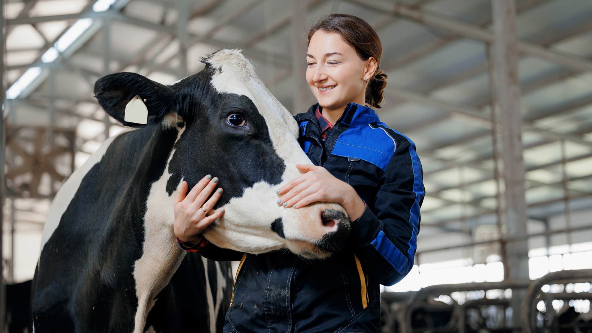 Woman smiling and hugging a cow