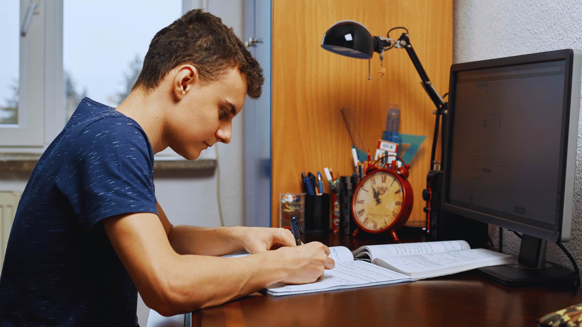 boy doing his homework before anything else