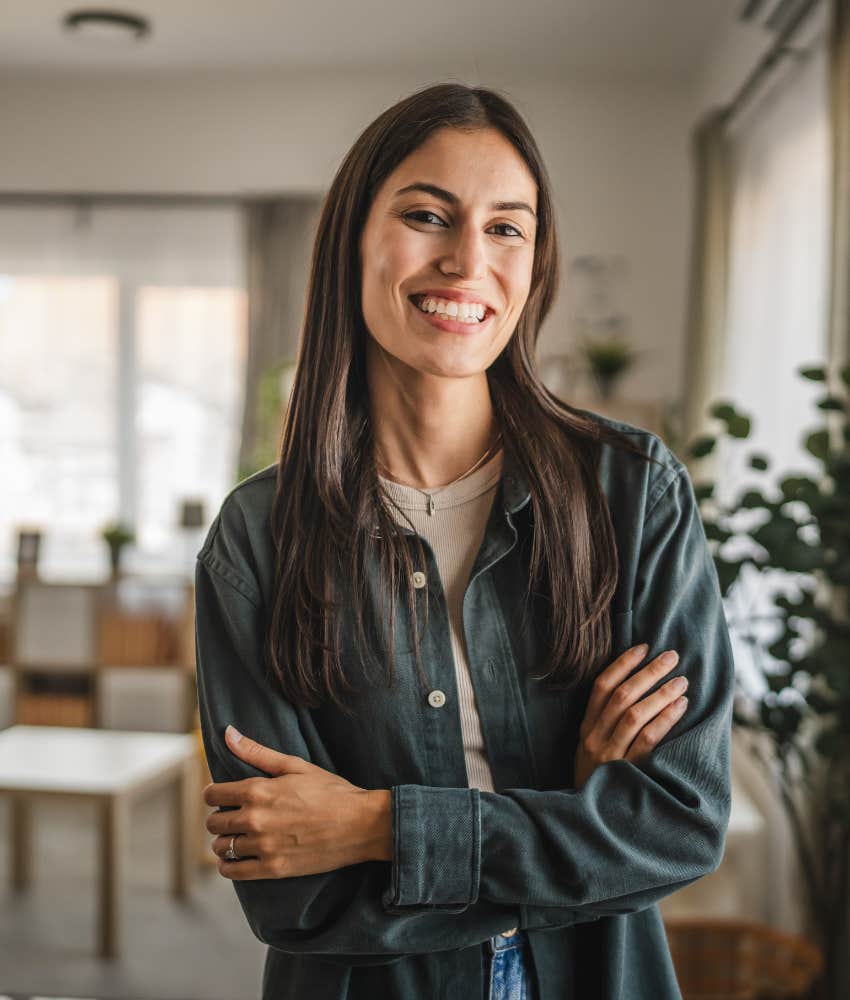 Strong, independent woman standing in an office confidently 