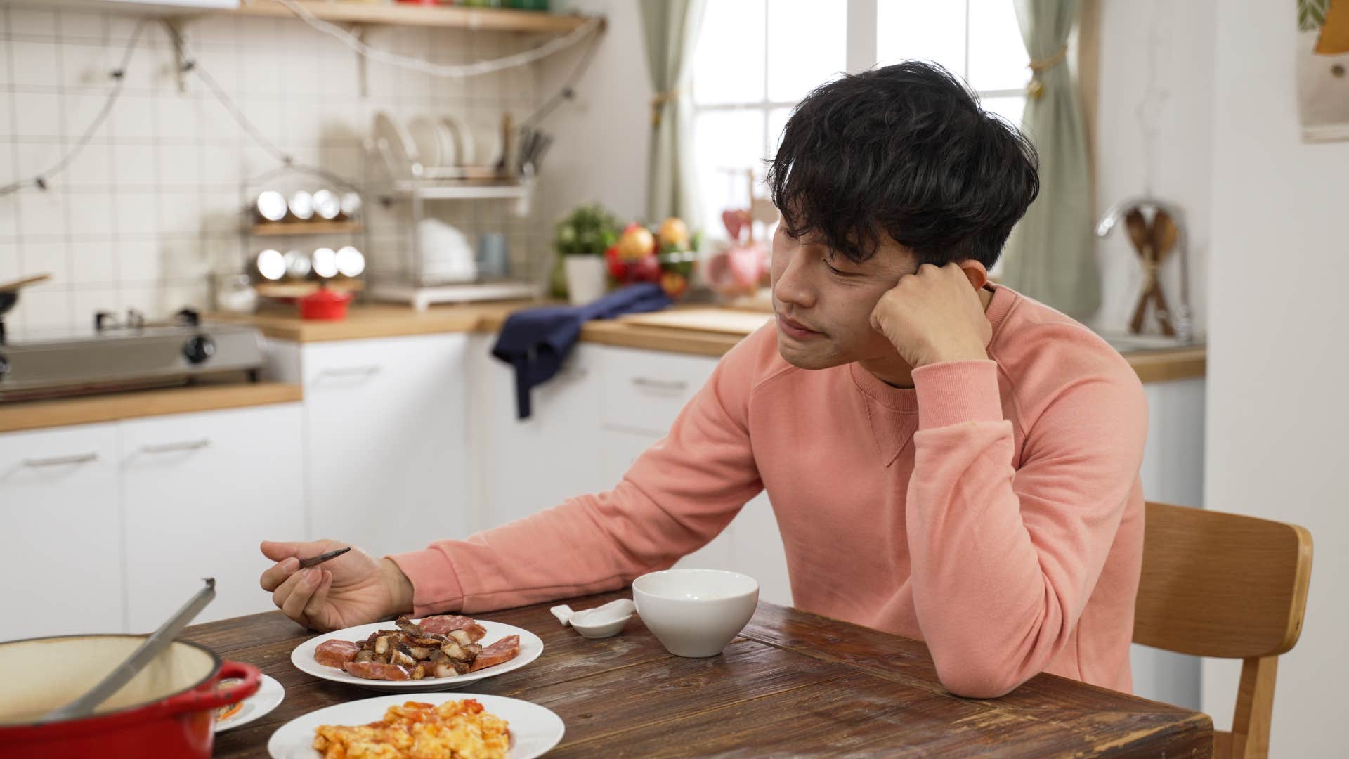 Chronically single man eating alone