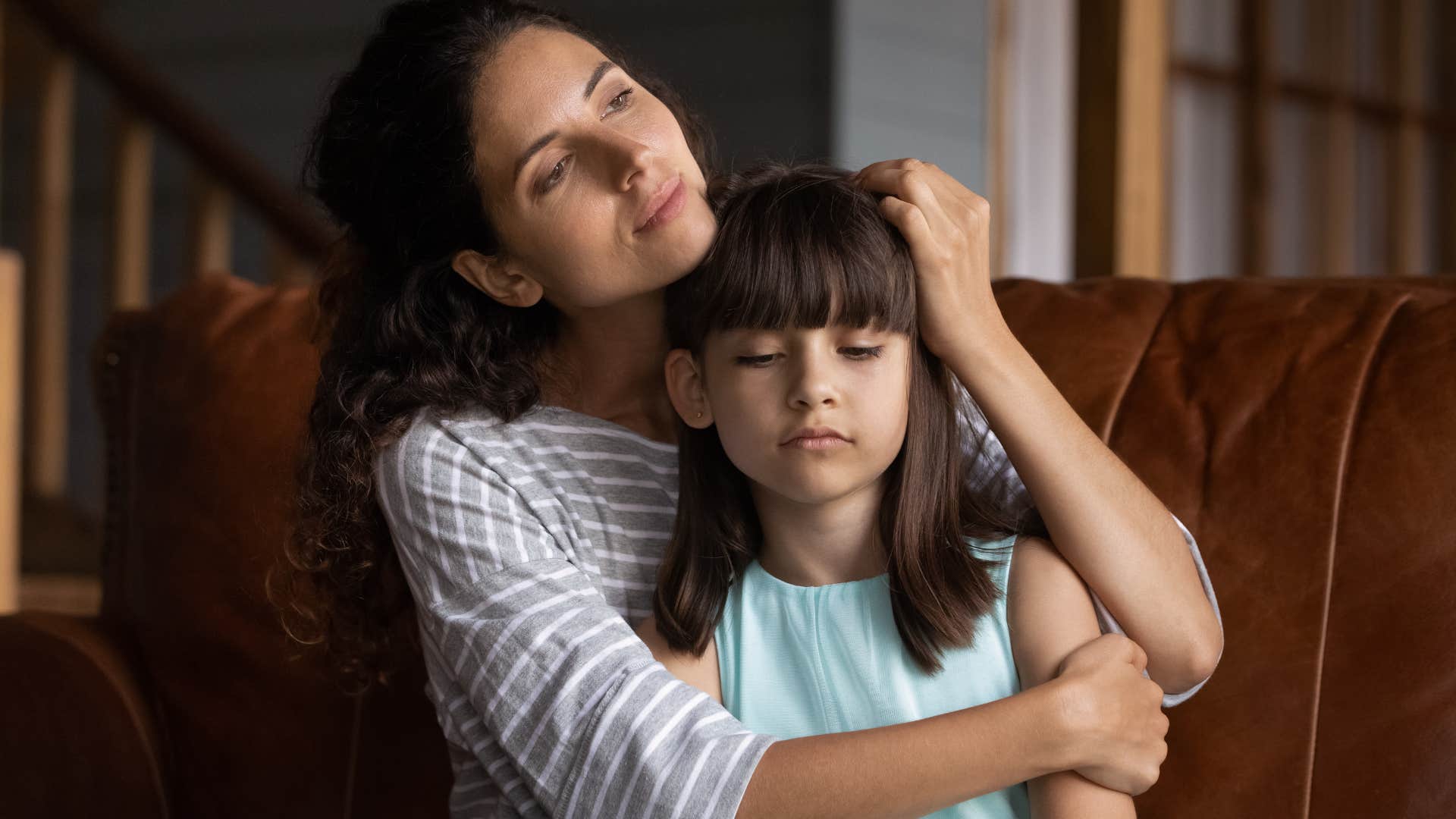 mom comforting upset daughter