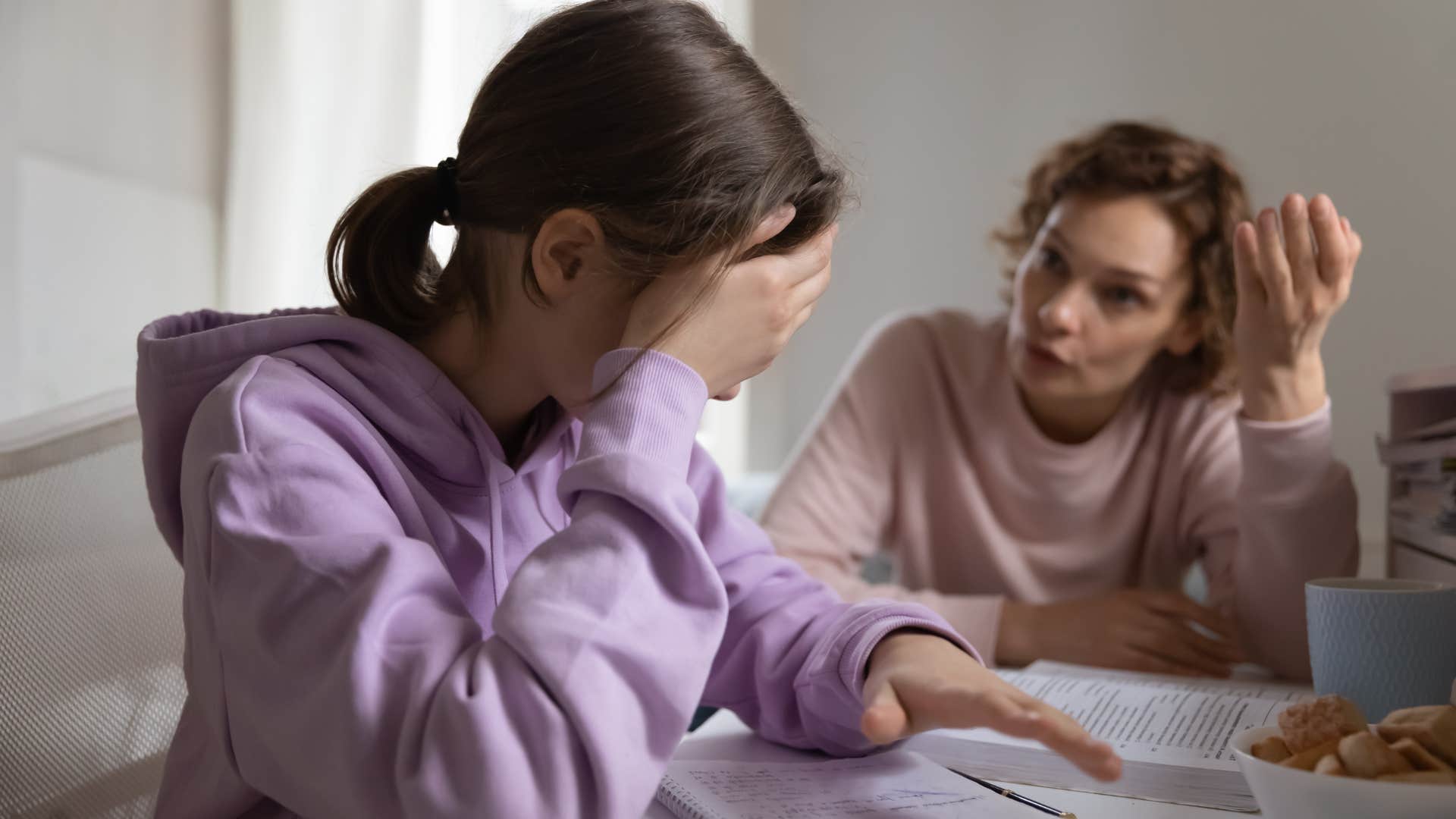 woman talking to her upset teenage daughter