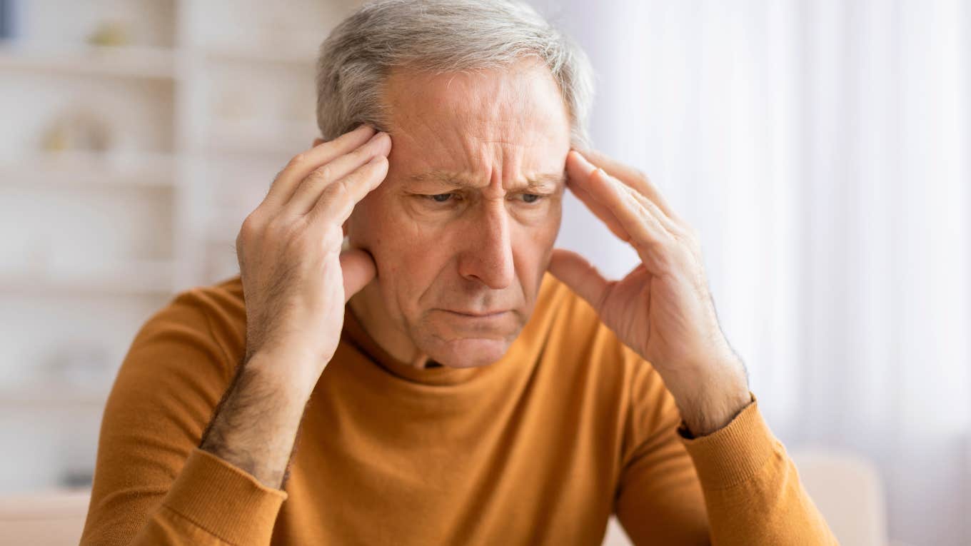 stressed older man with his hands on his head