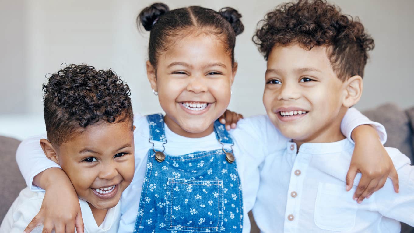 Three siblings hugging