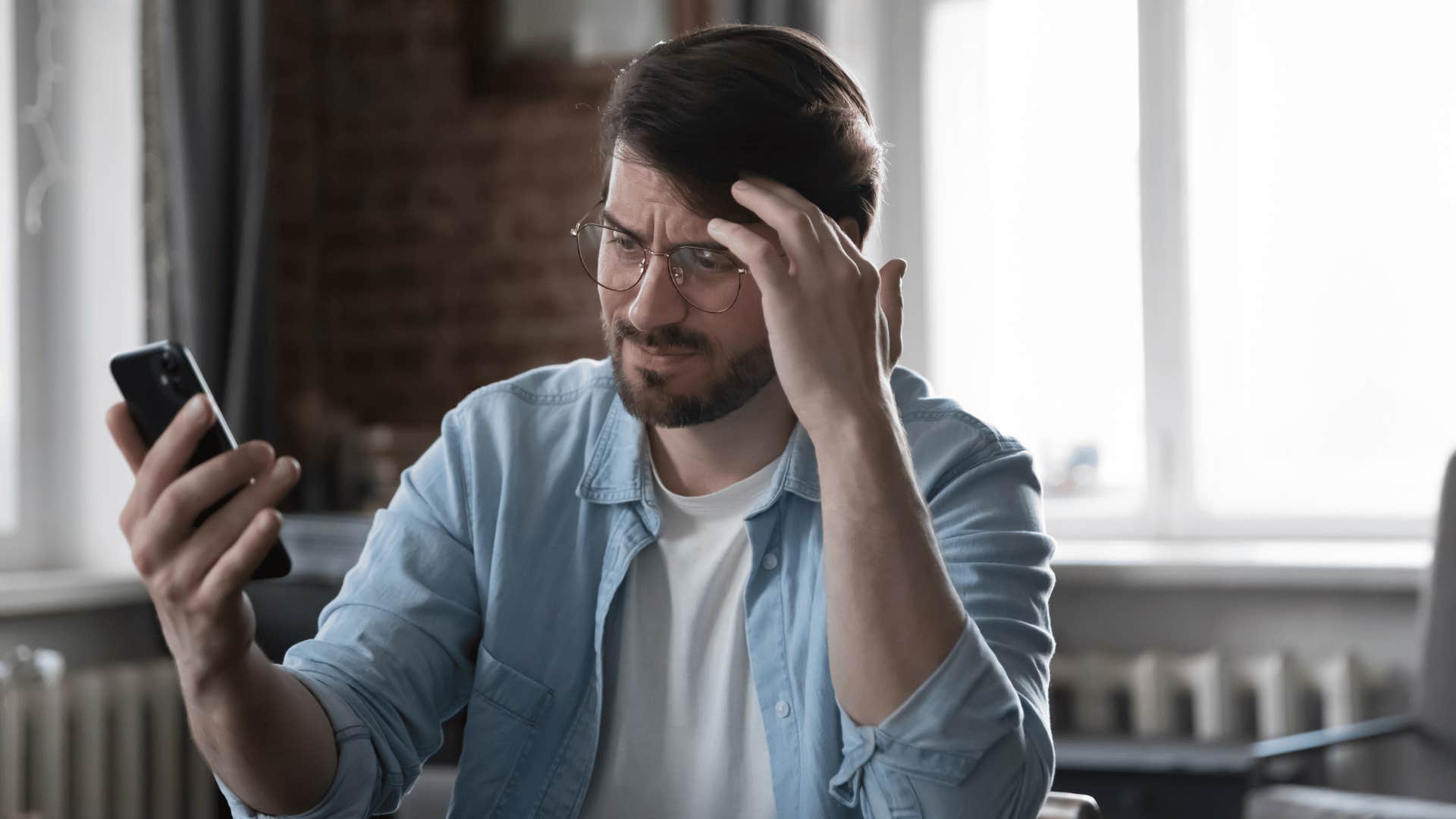 man looking frustrated with phone