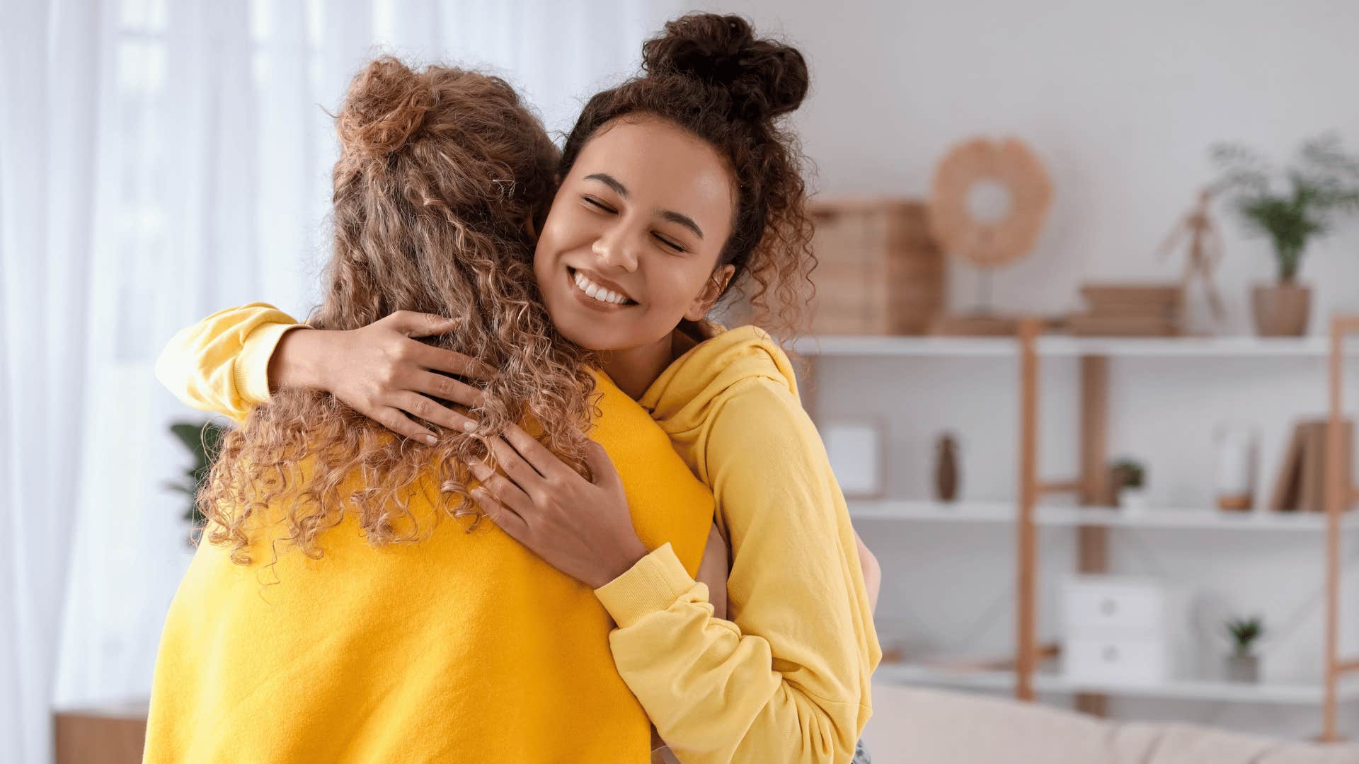 two women hugging and smiling 