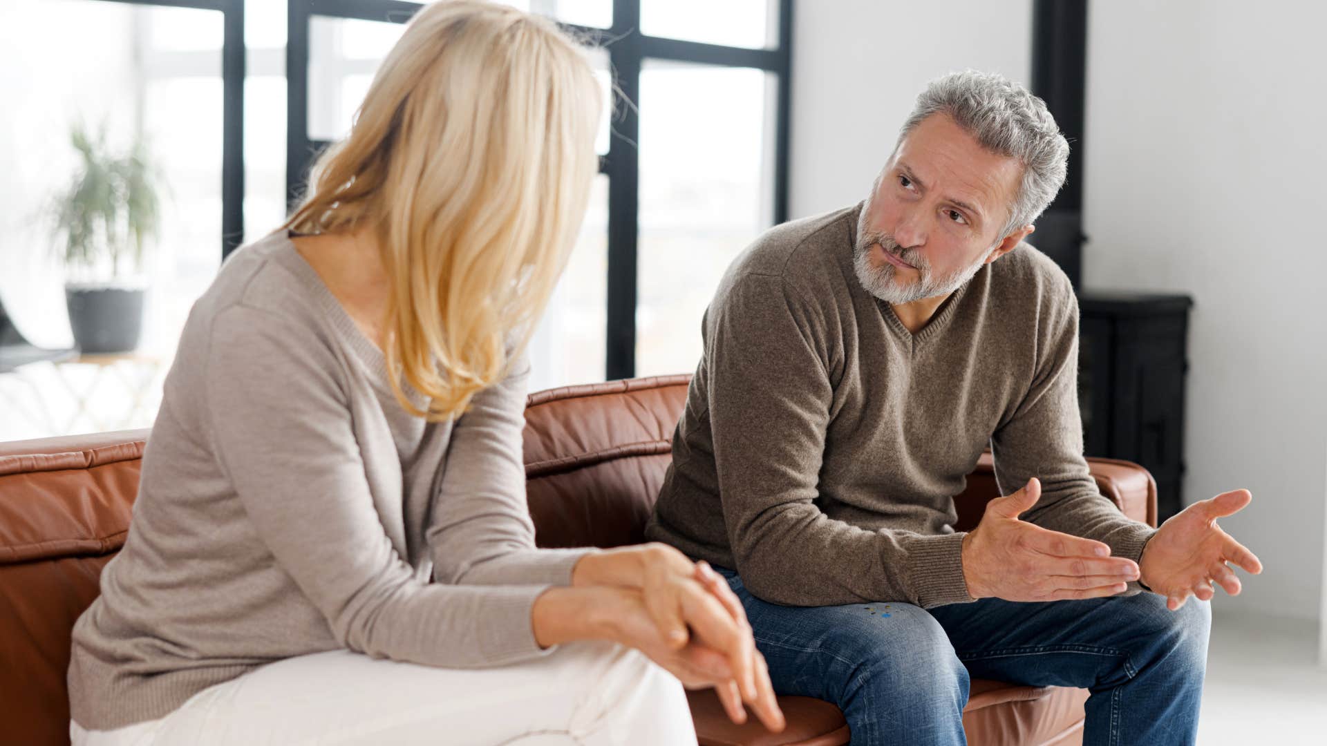 Man looking upset talking to his wife