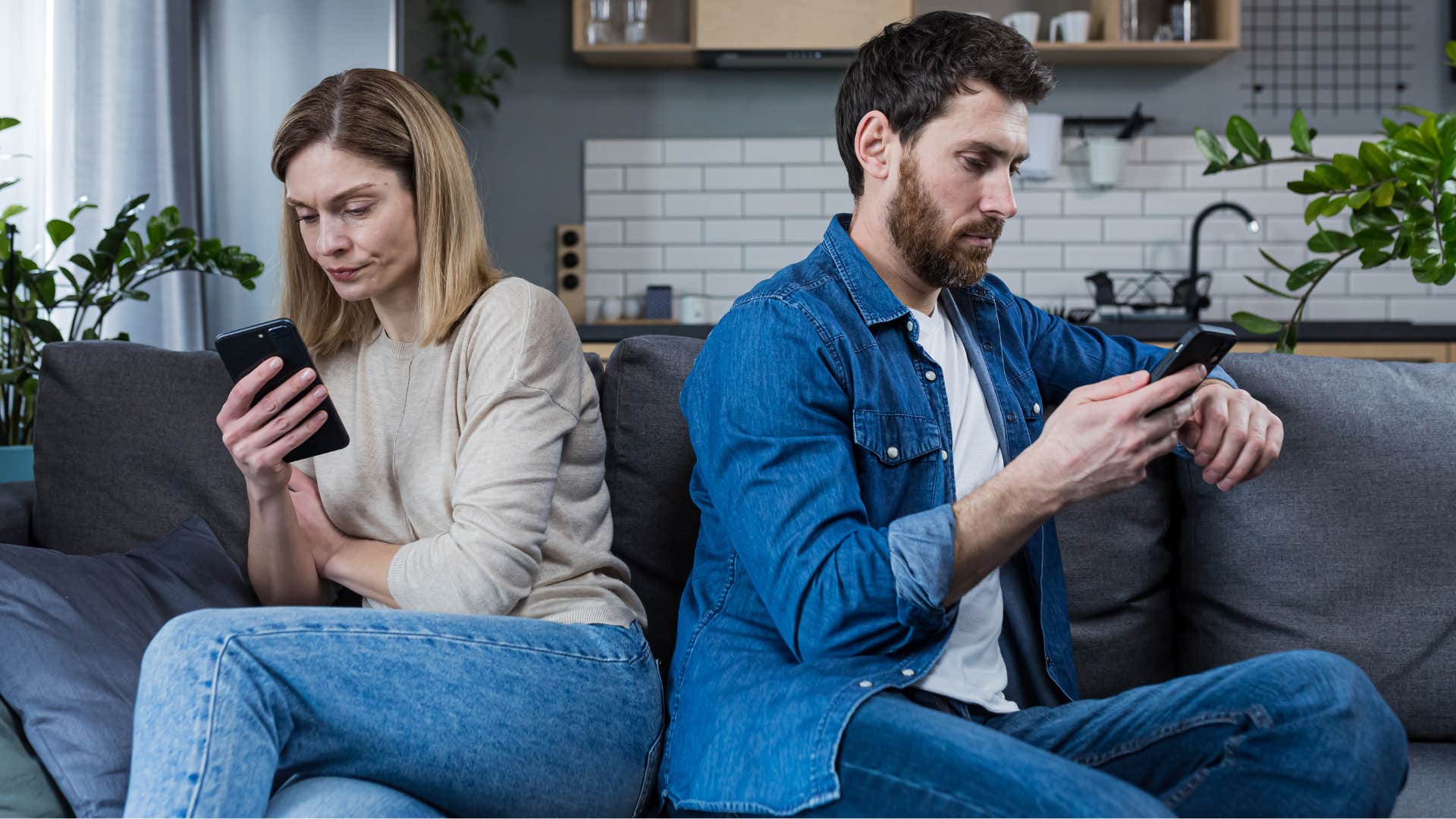 Married couple sitting away from each other on their phones