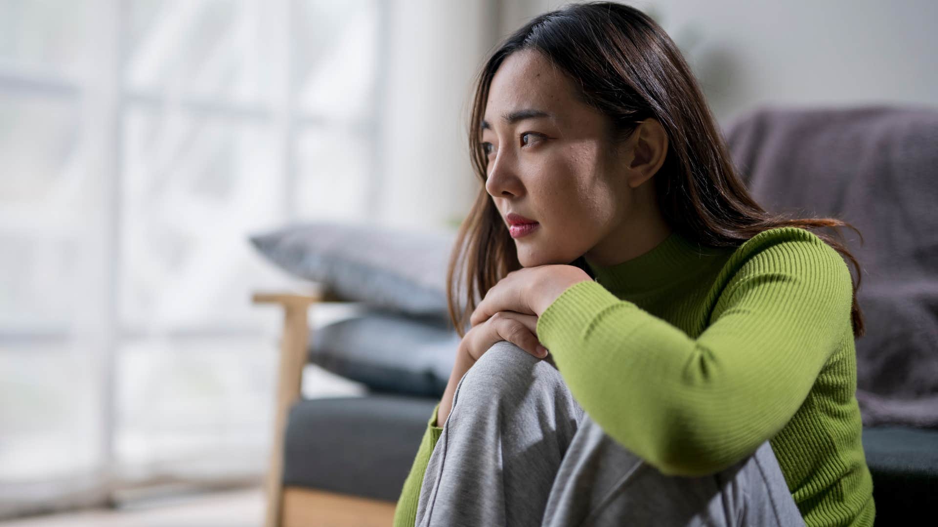 Lonely and sad woman sitting at home