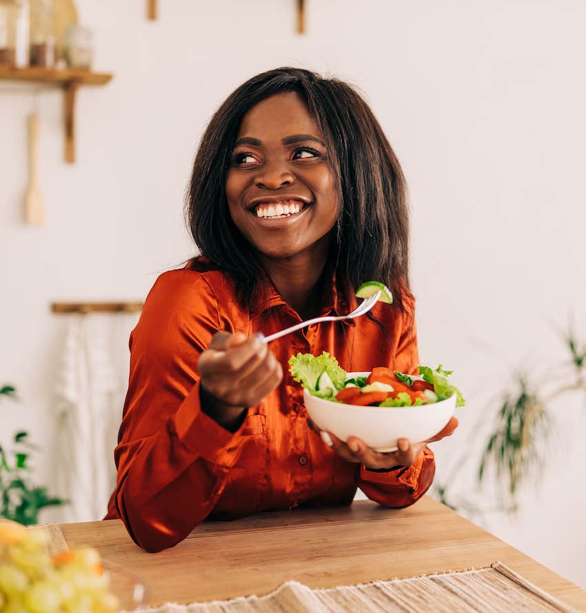 Health conscious woman enjoys a salad to reduce risk of heart disease