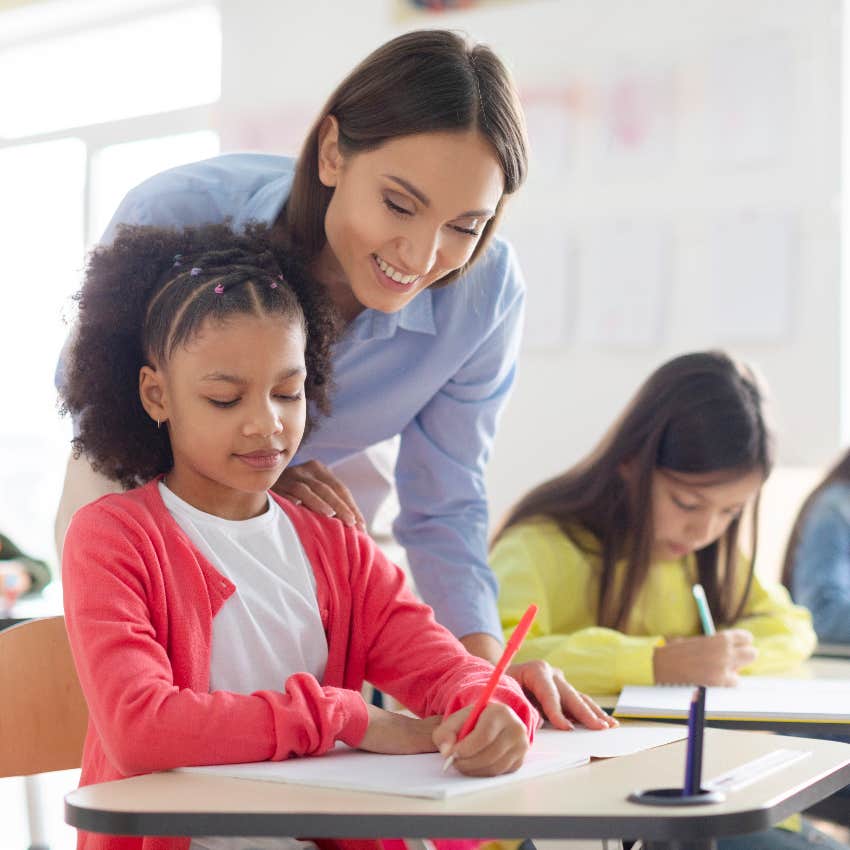 Teacher helping student