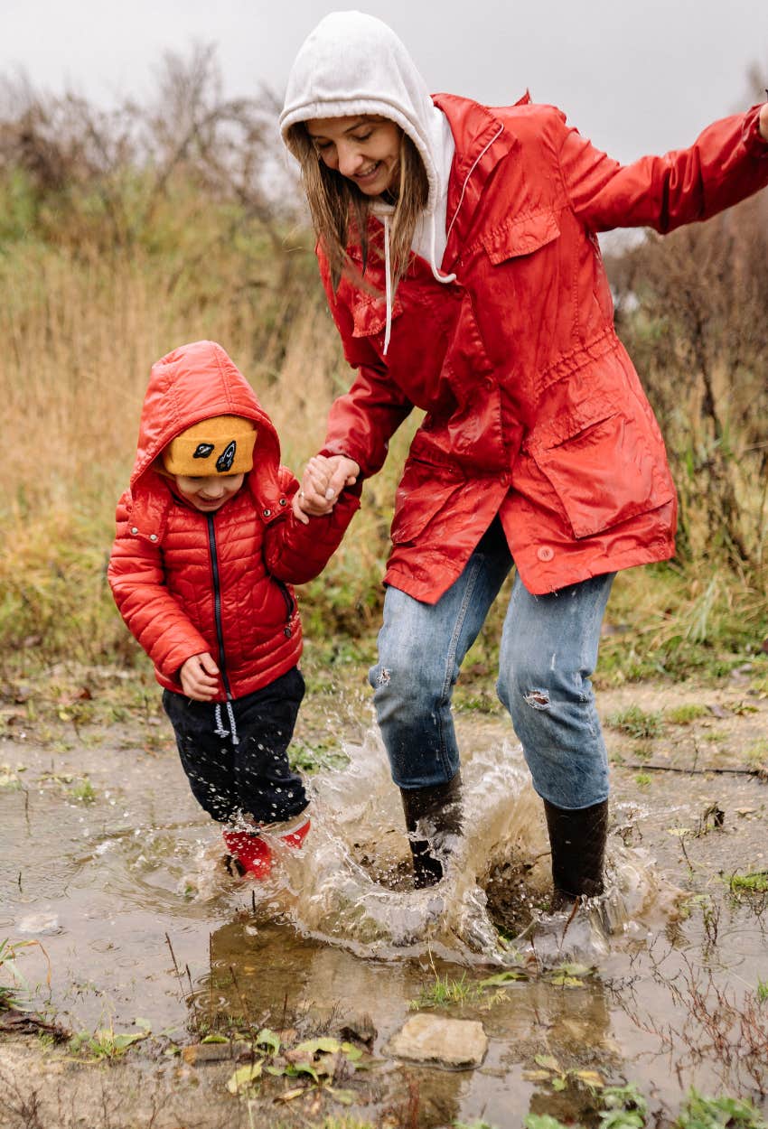 mom and child splashing in mud puddles