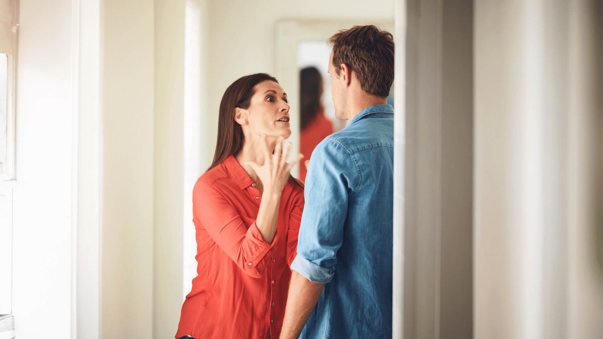 couple arguing in doorway