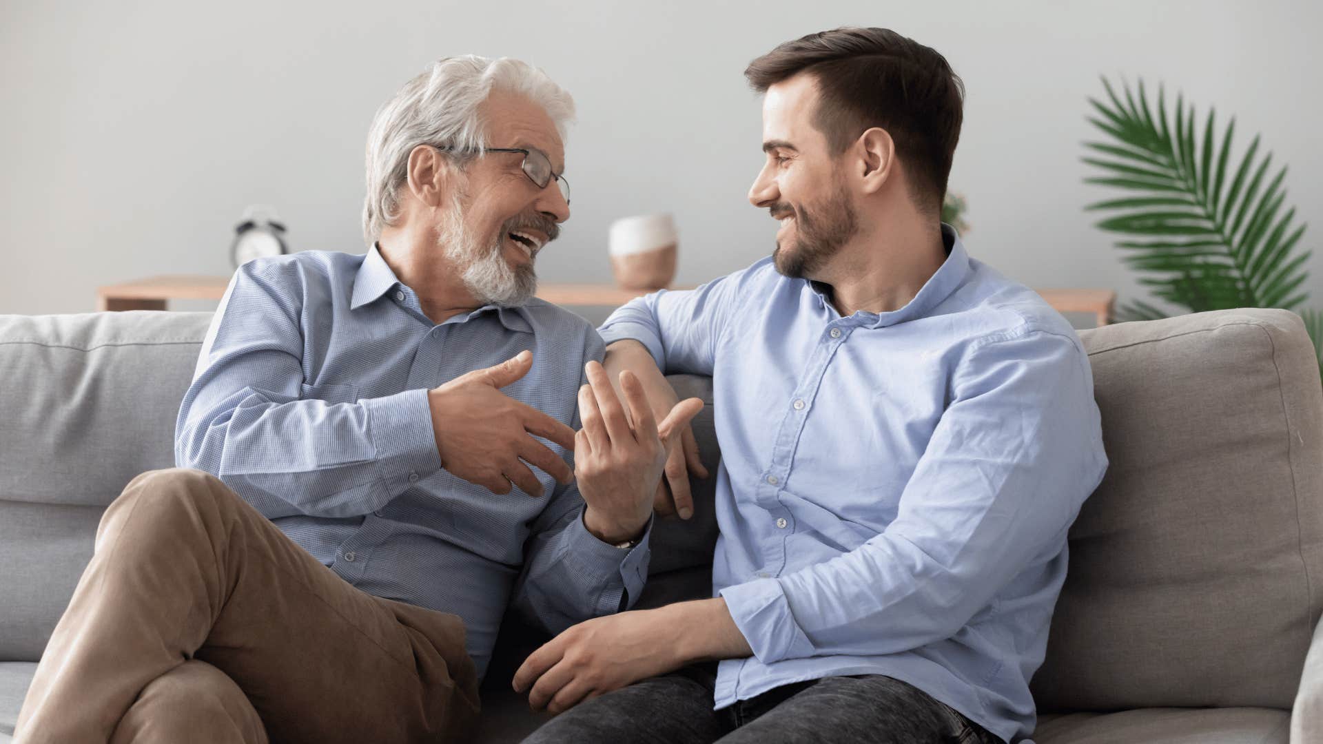 two men talking on the couch