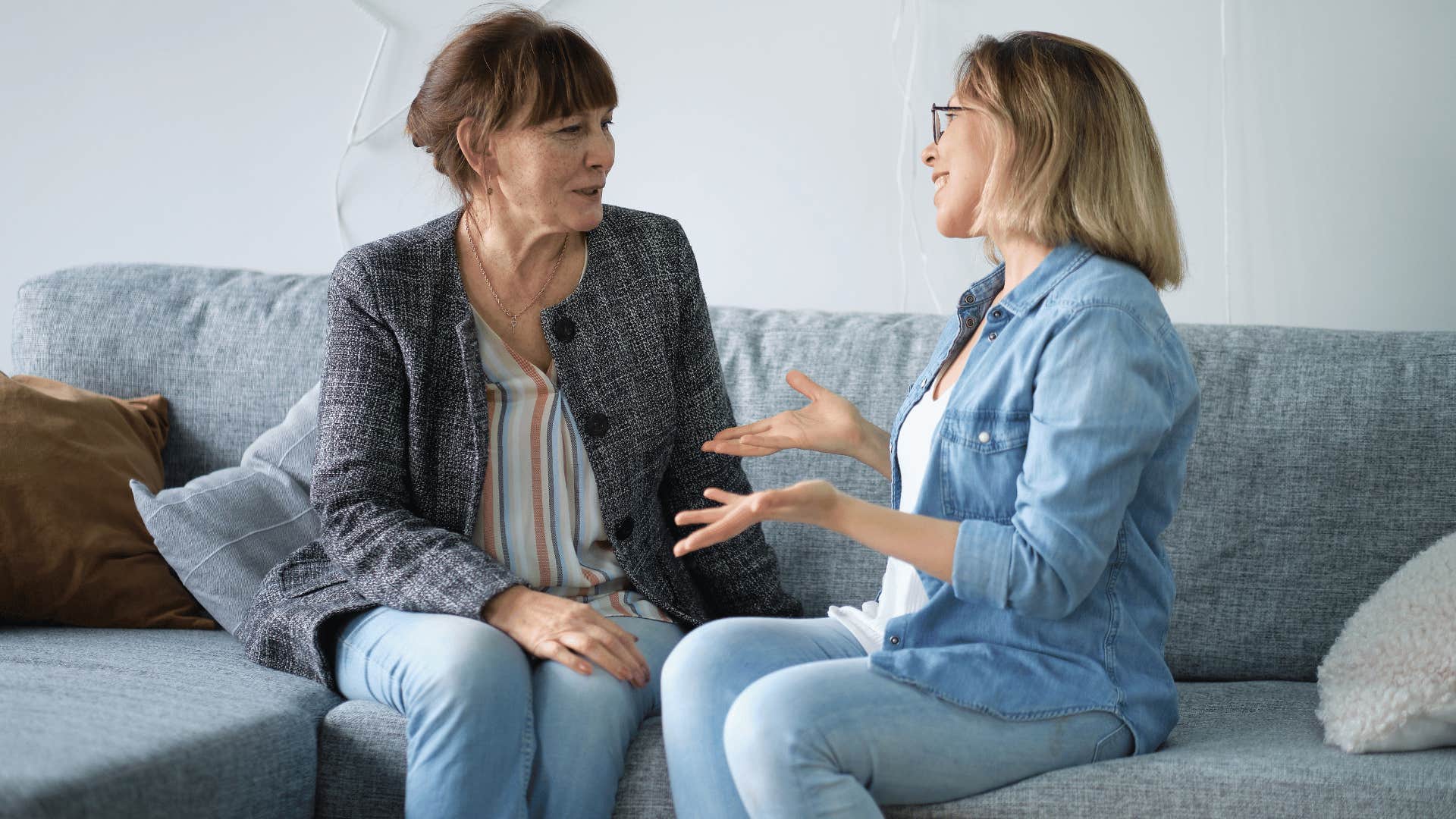 two women talking on the couch